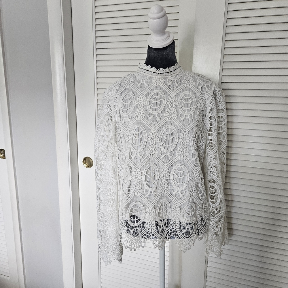 Ultra Pink bright white lace shirt with mock neck and long bell sleeve. Size L